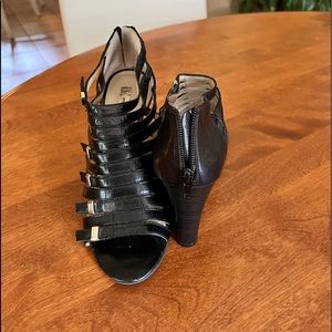 Cute black wedge sandals with gold detail on straps.